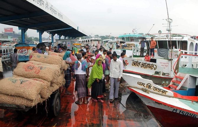 Although Barisal river port authorities have imposed a ban on plying of small launches on different routes of Barisal and Bhola districts in inclement weather, the operators of the small vessels are carrying goods and passengers, defying the ban. This photo was taken from Barisal river port yesterday noon. Photo: Star