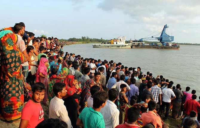 Relatives and villagers gather on the bank of Golachipa river in Patuakhali where a launch capsized Saturday afternoon. Photo: Star