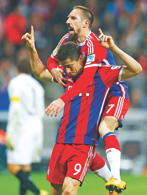 Robert Lewandowski of Bayern (bottom) celebrates his opening goal against his former team yesterday. Photo: AFP