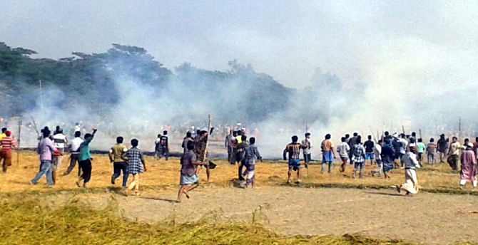 People of two villages in Sarail of Brahmanbaria lock in a clash over a trivial matter yesterday. The clash left scores injured and several homes vandalised, looted and torched. Photo: Banglar Chokh