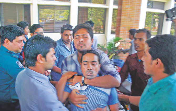 Saiful Islam Titu, a member of Barisal city Jubo League, being manhandled by men allegedly led by the city Bangladesh Chhatra League President Jasimuddin at Local Government Engineering Department Barisal office yesterday. He had gone there to drop his bid for a Tk 21.9 crore Coastal Climate Resilient Infrastructures Project, being funded by the government and Asian Development Bank. Photo: Star