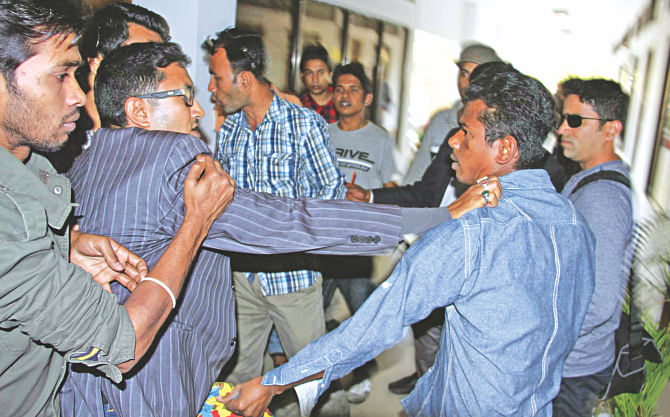 A Jubo League man, in striped suit, fist-fights with a Bangladesh Chhatra League activist at the LGED office in Barisal city. The followers of the two pro-Awami League organisations clashed yesterday to keep each other out from bidding for a Tk 10 crore infrastructure development work. Photo: Arifur Rahman