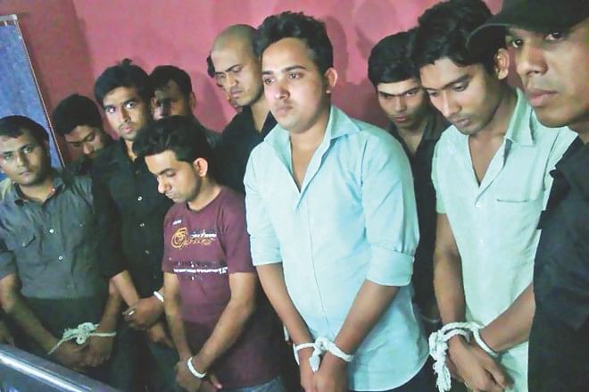 Twelve arrested youths, including a Bangladesh Chhatra League leader of Dhaka University, Al-Imran, third from right, at a Baridhara DOHS house in the capital yesterday where they operated a 