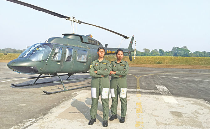 Tamanna and Nayma, right, in front of their Bell 206 helicopter. They have become the first female combat pilots of the Bangladesh Air Force. The photo was taken after they had completed their solo flying test at BAF base Bir Shrestha Matiur Rahman in Jessore.  Photo: Hasan Jahid Tusher 