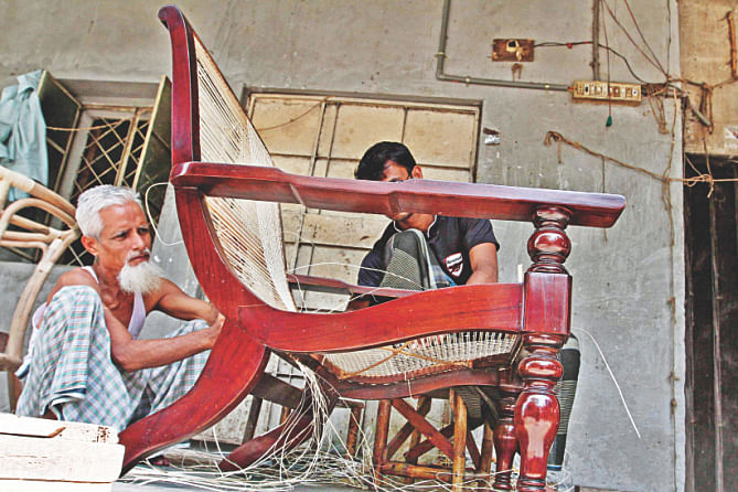 Workers of entrepreneur Hashem making furniture out of canes at their workshop at Banani in the capital. Photo: Anisur Rahman