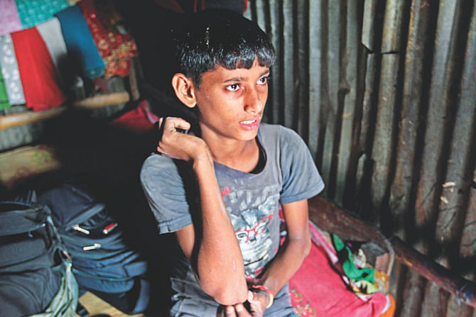 Rashed, 11, shows scars from the torture.  Photo: Star