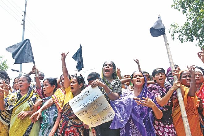 Biharis bring out a procession in front of Kurmitola Bihari camp in Mirpur, demanding justice for the killing of 10 people in the Saturday morning arson.  Photo: Palash Khan