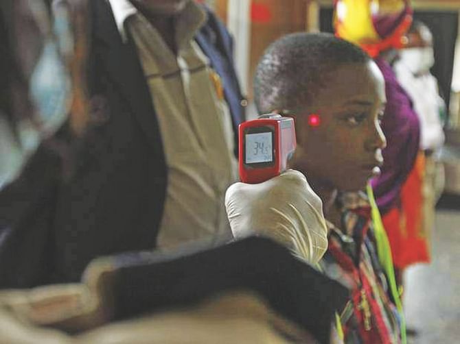 A boy's temperature is taken using an infrared laser thermometer at the international airport in Abuja, Nigeria. The country was declared Ebola-free yesterday.  Photo: Independent.co.uk