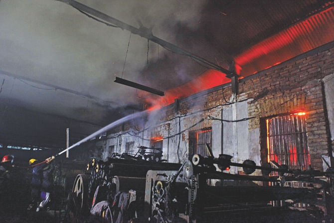 Firefighters try to douse the blaze at a factory in Old Dhaka yesterday.    Photo: Star