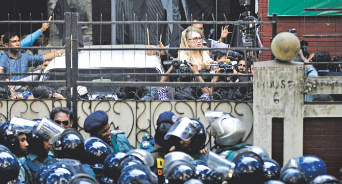 Confined to her Gulshan office since Saturday night, BNP Chairperson Khaleda Zia speaks to her party men and the press yesterday from inside the office premises, cordoned off by law enforcers. Photo: Rashed Shumon