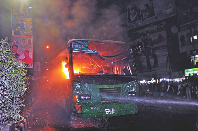 A bus put to the torch at Shahbagh in the capital though it was supposed to be outside the restrictions of the blockade. Photo: Star, Banglar Chokh
