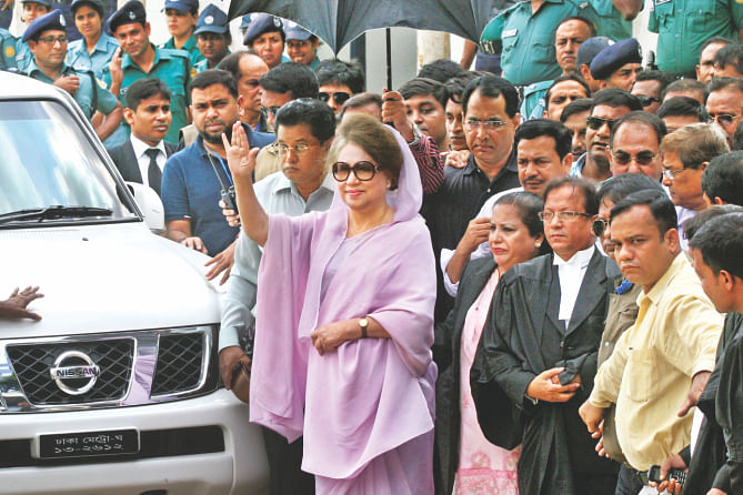BNP Chairperson Khaleda Zia waves to her supporters as she appears before a Dhaka court in the capital to attend the hearing in the Zia Orphanage and Zia Charitable Trust graft cases yesterday. Photo: Palash Khan
