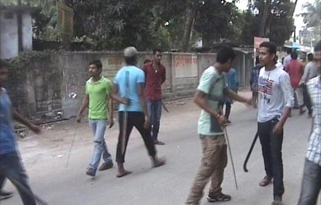 Activists of newly formed BNP Rangpur district unit with sticks and sharp weapons after clashing with another faction at Shalban in Rangpur city yesterday which left 30 injured. Photo: Star