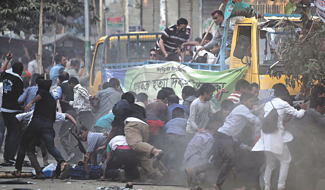 Activists of the 20-party combine run for cover during a clash with police at the venue of a ‘Democracy Killing Day’ rally on Nur Ahmed Road in Chittagong yesterday. Photo: Anurup Kanti Das