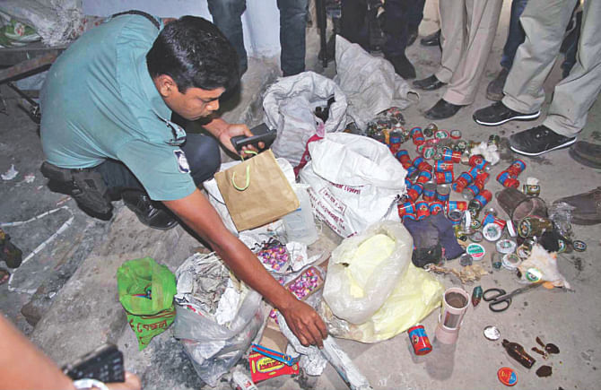A police official examines bomb-making materials, which were recovered from two Islami Chhatra Shibir-dominated dormitories of Chittagong College in the city yesterday.  Photo: Star