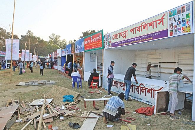 Although Amar Ekushey Grantha Mela 2014 was inaugurated on Saturday, some of these stalls falling in the portion of the fair in the capital's Suhrawardy Udyan had not still completed decorations, let alone start selling books. The photo was taken yesterday. Photo: Palash Khan