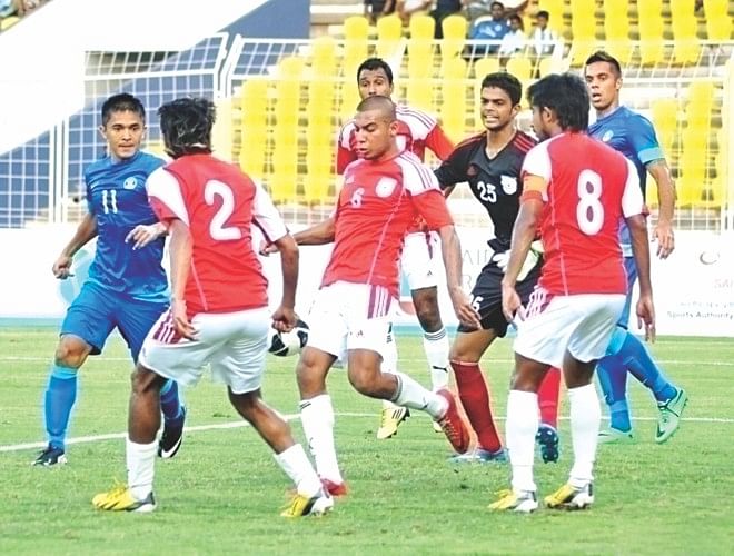 Bangladesh defenders scramble clear an Indian attack during their FIFA International Friendly at the Jawaharlal Nehru Stadium in Margao, Goa yesterday. PHOTO:  INTERNET