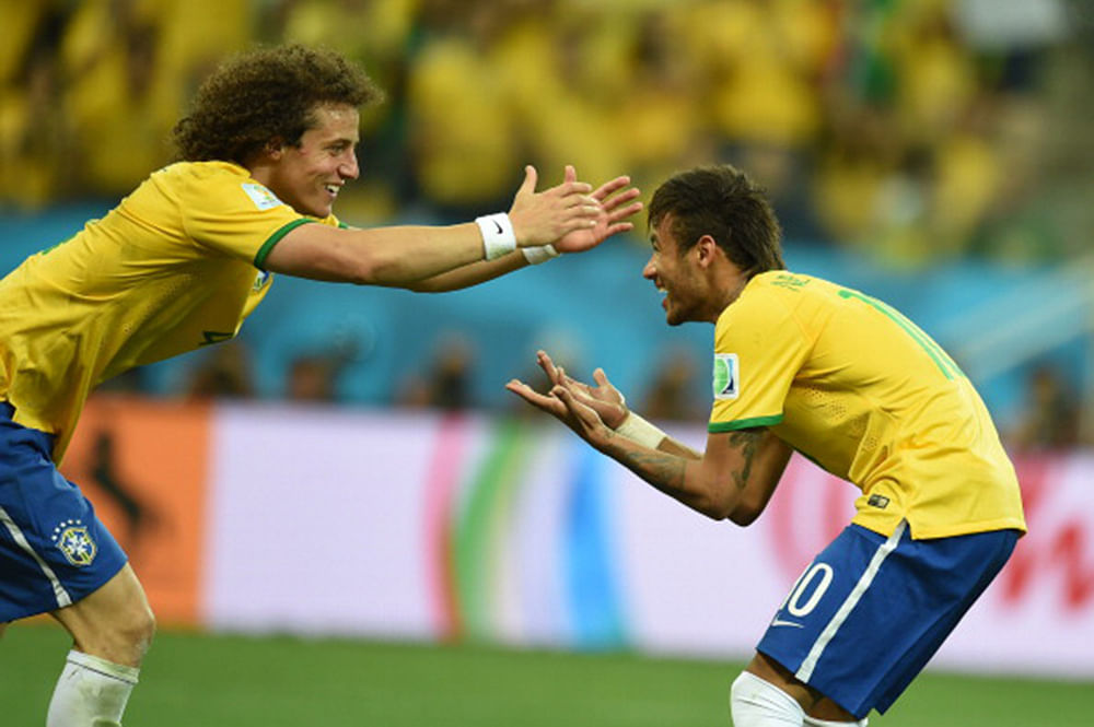 Brazil's forward Neymar (R) celebrates with his teammate defender David Luiz after scoring a penalty during a Group A football match between Brazil and Croatia at the Corinthians Arena in Sao Paulo during the 2014 FIFA World Cup on June 12, 2014. Photo: AFP/Getty Images