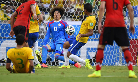Mexico's goalkeeper Guillermo Ochoa (C) kicks the ball during a Group A football match between Brazil and Mexico in the Castelao Stadium in Fortaleza during the 2014 FIFA World Cup. Photo: AFP/Getty Images