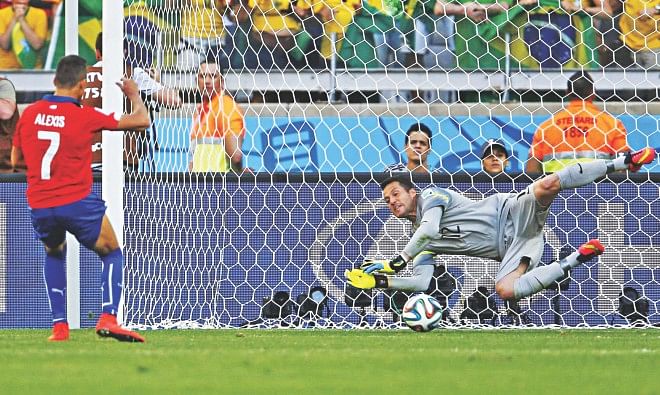 Brazil goalkeeper Julio Cesar saves a spot-kick from Chile forward Alexis Sanchez during the penalty shootout of the World Cup round of 16 match at the Mineirao Stadium in Belo Horizonte yesterday. Brazil won 3-2 on penalties. PHOTO: REUTERS