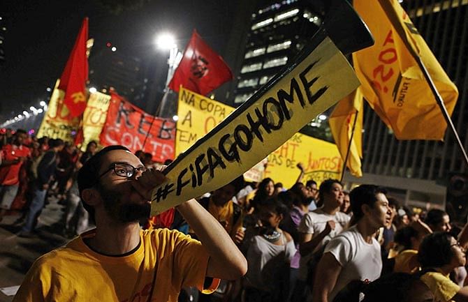 A demonstrator blows a horn during a protest against the 2014 World Cup, in Sao Paulo May 15, 2014. Photo: Reuters