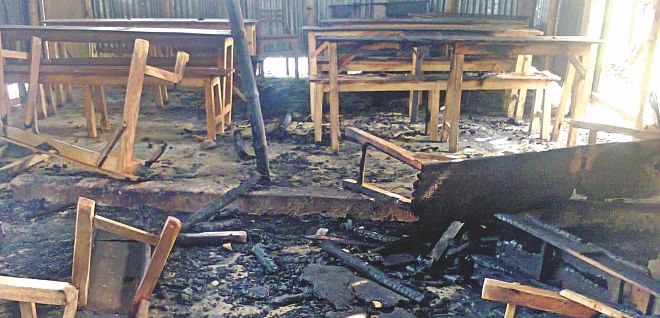 The charred and broken school benches of Kalabipara Adarsha High School in Rajshahi after alleged opposition activists early yesterday torched the educational institution even though it was not supposed to be a polling centre during today's elections. Photo: Star