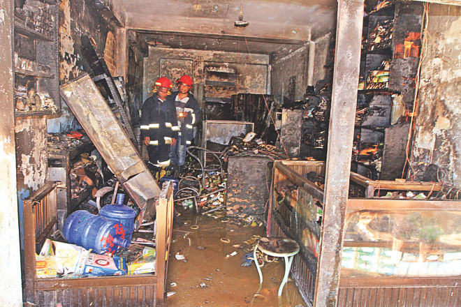 Firemen inspecting the devastated shop after the chemical explosion yesterday afternoon at Tejturi Bazar in the capital. Photo: Palash Khan, Anisur Rahman