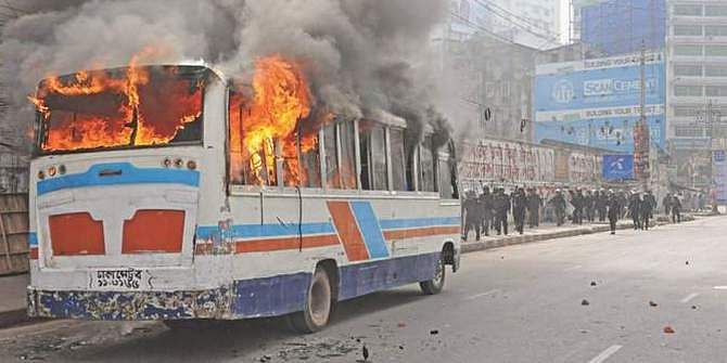 A minibus is set ablaze near Dainik Bangla intersection in Dhaka on February 13, 2013 during a clash between Jamaat-Shibir activists and law enforcers. Photo: STAR