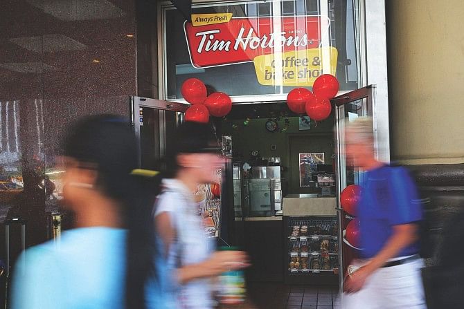 People walk past a Tim Horton's cafe in Manhattan in New York City. Photo: AFP