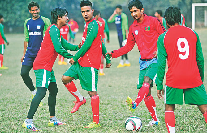Bangladesh captain Mamunul Islam (2nd from L) shares a light moment with his teammates during a training session at the BUET ground yesterday, ahead of today's friendly match against Japan U-21s. Photo: Star