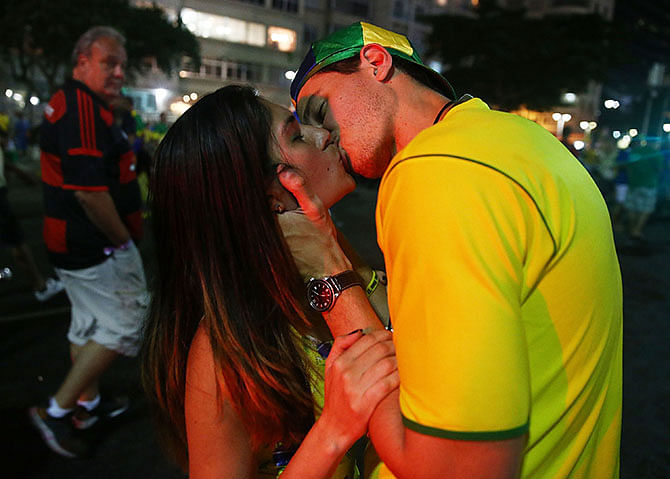 Brazil fans kiss and celebrate in Copacabana following their victory in their 2014 FIFA World Cup match against Colombia. Photo: Getty Images