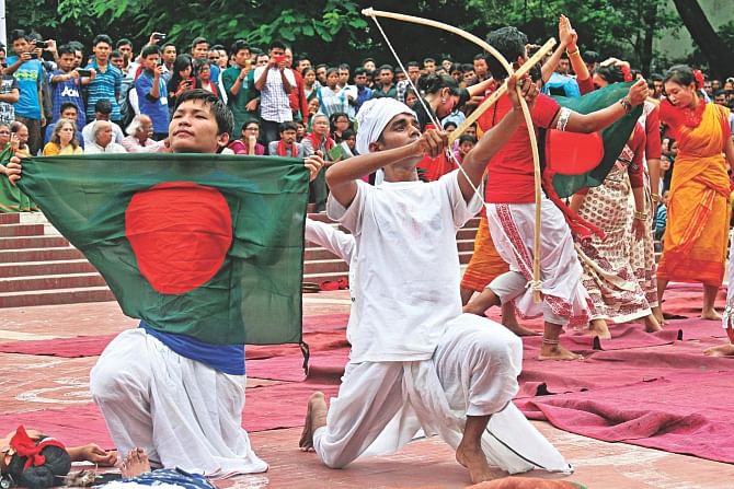 Indigenous people performing at the Central Shaheed Minar yesterday in observance of International Day of the World's Indigenous Peoples. Bangladesh Adivasi Forum organised the event where almost every banner and festoon had the word “adivasi” on it.  Photo: Anisur Rahman