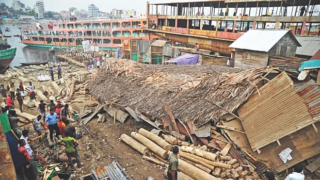 An illegally built log shed knocked down by an eviction team from the BIWTA and Dhaka district administration, which carried out a drive in Keraniganj to free the shore of the Buriganga river yesterday. Photo: Firoze Ahmed