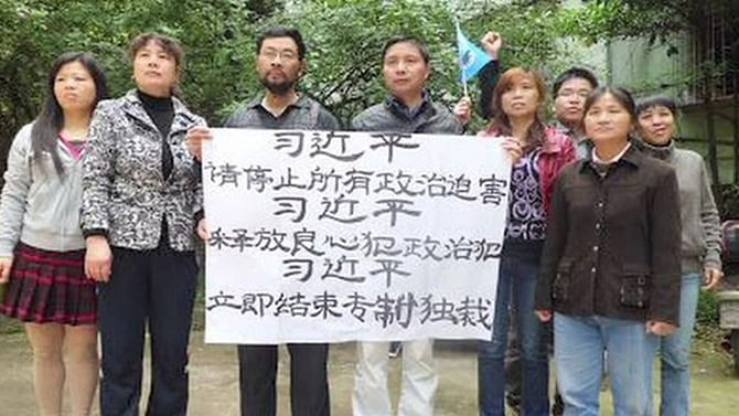 The activists with their banner New Citizens' Movement calls for more openness from the government. Photo: BBC