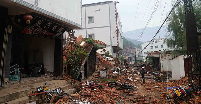 Debris of collapsed houses are seen scattered along a street, after a deadly earthquake hit Longtoushan town on Sunday, in Ludian county, Zhaotong, Yunnan province August 4.Photo: Reuters