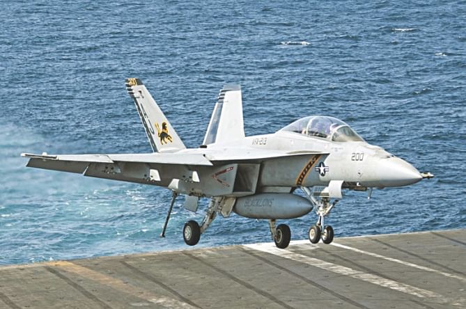 An F/A-18F Super Hornet lands aboard aircraft carrier USS George HW Bush in the Gulf after it struck IS targets. Photo: Reuters