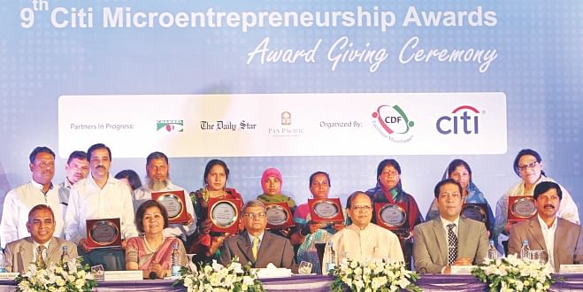 Recipients of Citi Microentrepreneurship Awards, in the background, pose with dignitaries and organisers at a ceremony at Sonargaon Hotel in Dhaka yesterday. Photo: Star 