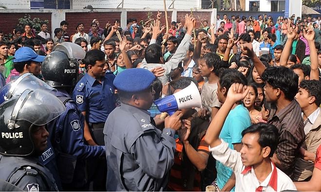 Police try to calm the agitated workers in the Chittagong Export Processing Zone yesterday. Photo: Anurup Kanti Das