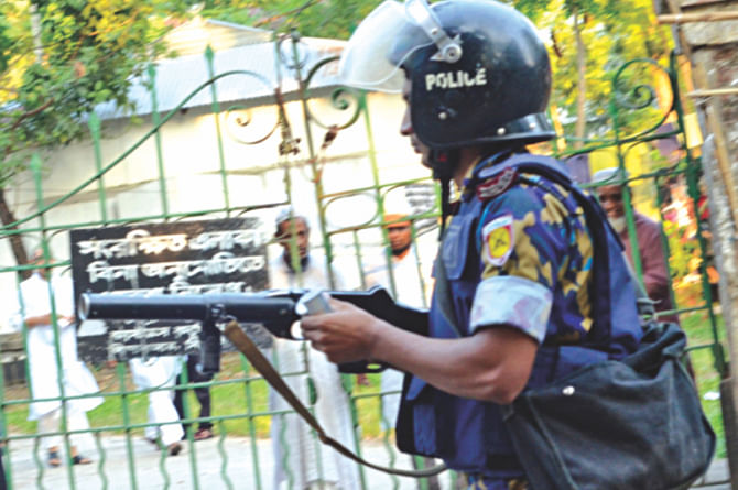 A policeman in action during a factional feud of Jatiyatabadi Chhatra Dal in Sylhet yesterday. Photo: Star