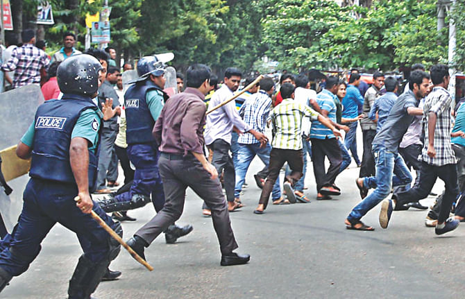 Police chase pickets in front of the BNP office at Nosimon Bhaban in Chittagong during the hartal enforced by the party-led alliance yesterday.  Photo: Star