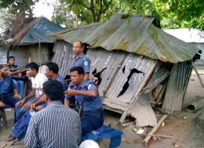 Policemen were deployed to stave off further unwarranted situation after yesterday's clash and vandalism at Chikney Bazar in Sadullapur upazila under Gaibandha district.  PHOTO: STAR