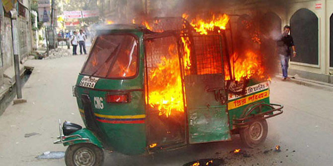 This November 27 photo shows a burning CNG-run auto rickshaw torched by pickets in Wari area of the capital during opposition enforced countrywide blockade. 