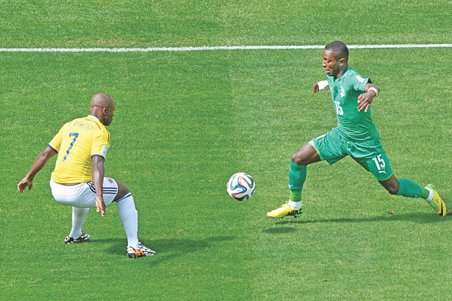 Ivory Coast midfielder Max-Alain Gradel tries to find a way past Colombia defender Pablo Armero during their World Cup Group C encounter at the Mane Garrincha National Stadium in Brasilia on Thursday. PHOTO: AFP