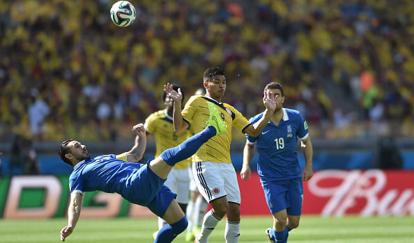Greece's midfielder Kostas Katsouranis (L) in action during a Group C football match between Colombia and Greece at the Mineirao Arena in Belo Horizonte during the 2014 FIFA World Cup on June 14, 2014. Photo:  AFP/Getty Images