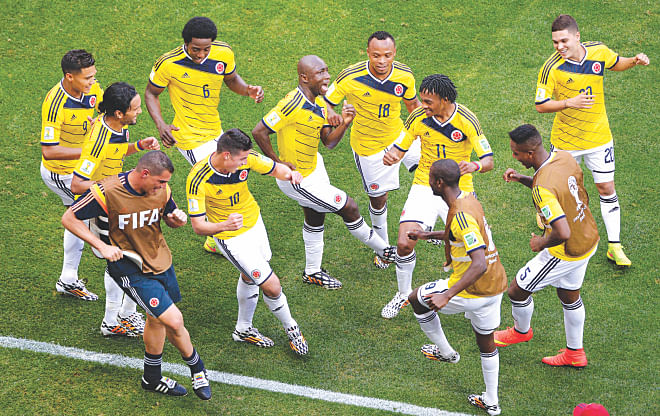 Colombia players dance to celebrate one of their two goals against Ivory Coast during a Group C match of the World Cup at the Mane Garrincha Stadium in Brasilia on Thursday. Colombia won the match 2-1.  PHOTO: AFP