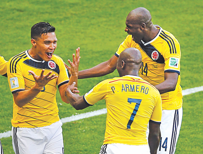 Colombia's Teofilo Gutierrez (L) is ecstatic after scoring his side's second goal during their Group C match against Greece in Belo Horizonte yesterday. The South Americans achieved their best World Cup final result by beating Greece 3-0. Story on S-1   Photo: REUTERS 