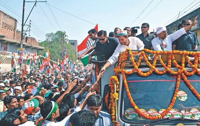 India's Congress Party Vice President Rahul Gandhi (3rd L, on truck) shakes hands with supporters as he campaigns with party candidate Ajay Rai (2nd R) in Varanasi yesterday. Campaigning in India's bitterly fought election ended yesterday ahead of next week's final voting with the Hindu nationalist opposition already scenting victory. Photo: AFP