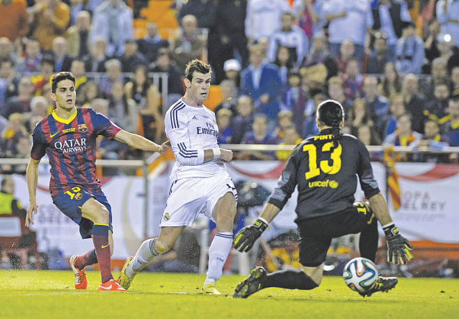 Real Madrid's Welsh forward Gareth Bale (C) finishes after a wonderful 58-metre run that started behind the halfway line against archrivals Barcelona during the Copa del Rey final at the Mestalla on Wednesday. Bale's effort proved to be the difference between the two sides. Photo: AFP