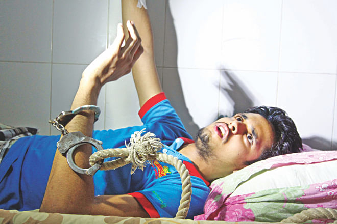 Inzamamul Islam cuffed to his bed at the burn unit of DMCH. He was hospitalised allegedly after police torture in custody.  Photo: Palash Khan