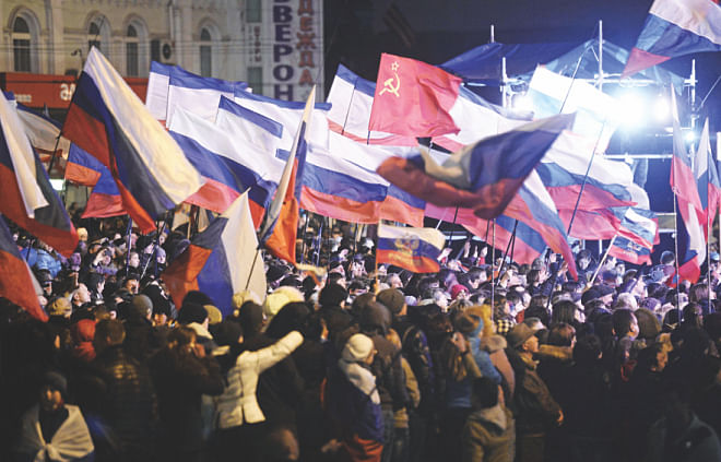 Pro-Russian Crimeans wave Russian flags as they gather to celebrate in Simferopol's Lenin Square on Sunday after exit polls showed that about 93 percent of voters in Ukraine's Crimea region supported union with Russia. Photo: AFP